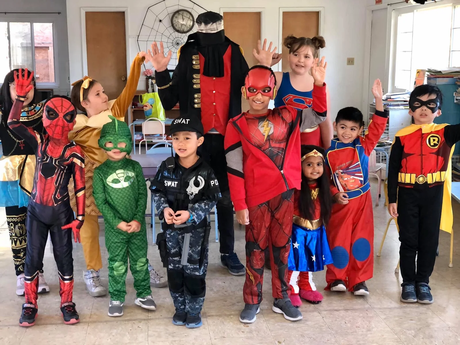Children in colorful costumes in the classroom