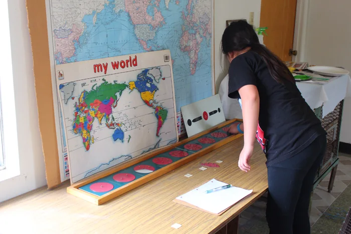 Student working with Montessori geography materials