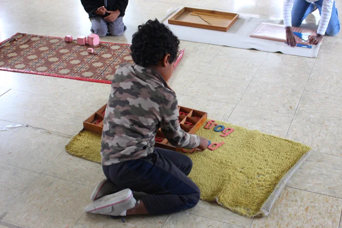 Child working with Montessori mathematics materials